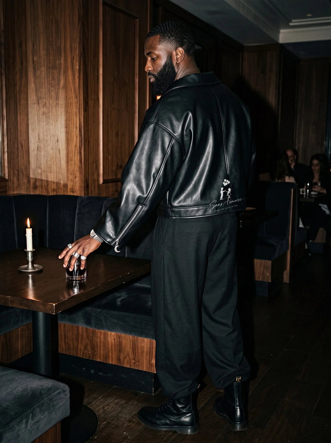 A man from behind in the jacket, the boy and girl graphic on its back