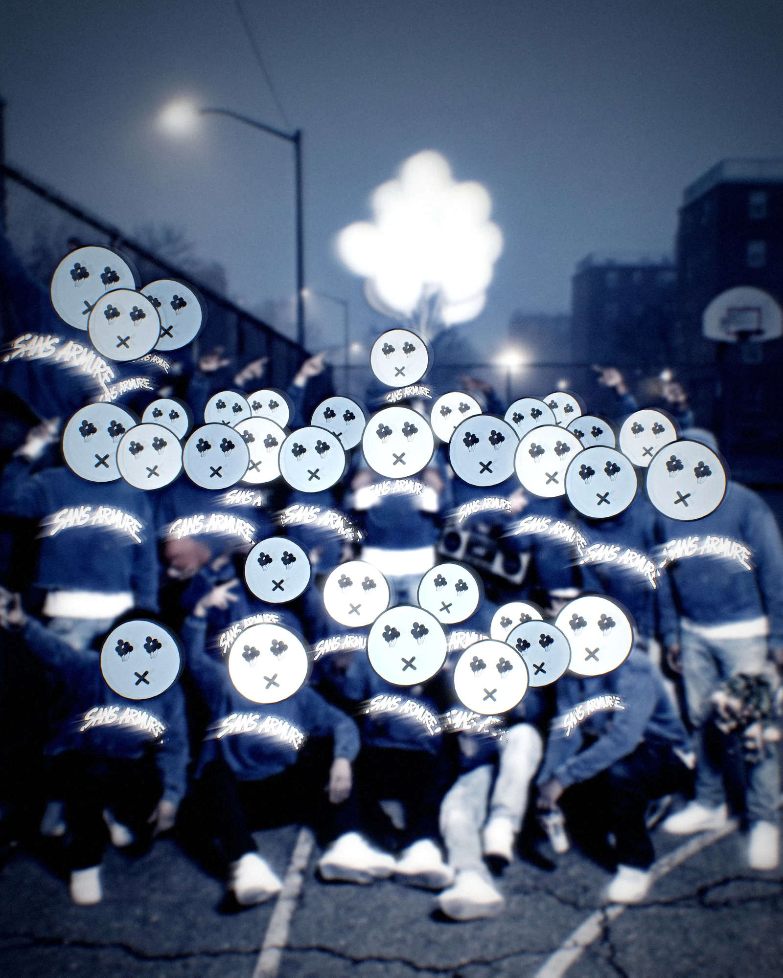 A crowd in blue Sans Armure hoodies on a night basketball court under white balloons