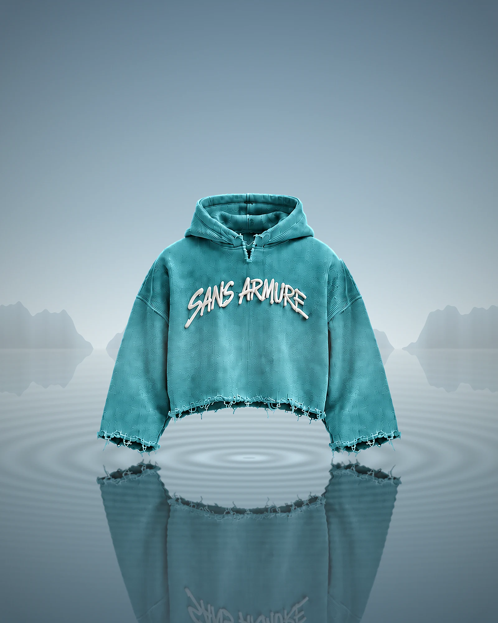 The Unfinished hoodie in teal, standing on still water